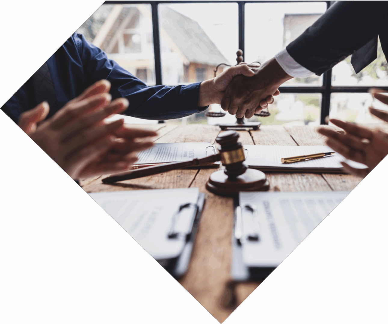 Handshake over legal documents and gavel